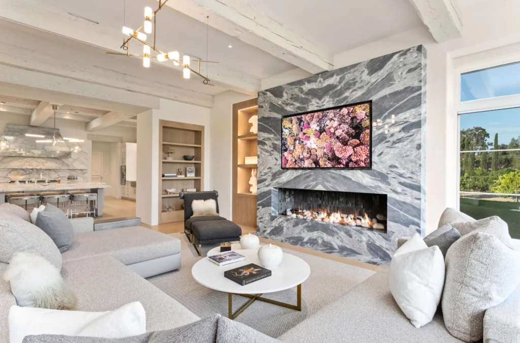 A cozy family room featuring comfortable and modern furniture, designed for family gatherings and relaxation. The room offers an inviting atmosphere with a stylish touch.