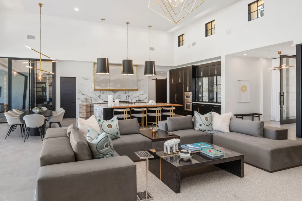 A stylish and contemporary living room designed with modern accents and a cozy atmosphere. The space features a mix of textures, including soft furniture and artistic decorations, making it a perfect place for relaxation.